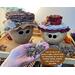 Handmade apple gourds with happy faces carved into the shells. This shows the gourds named Apple and Mac as  their  custom hats are made. 